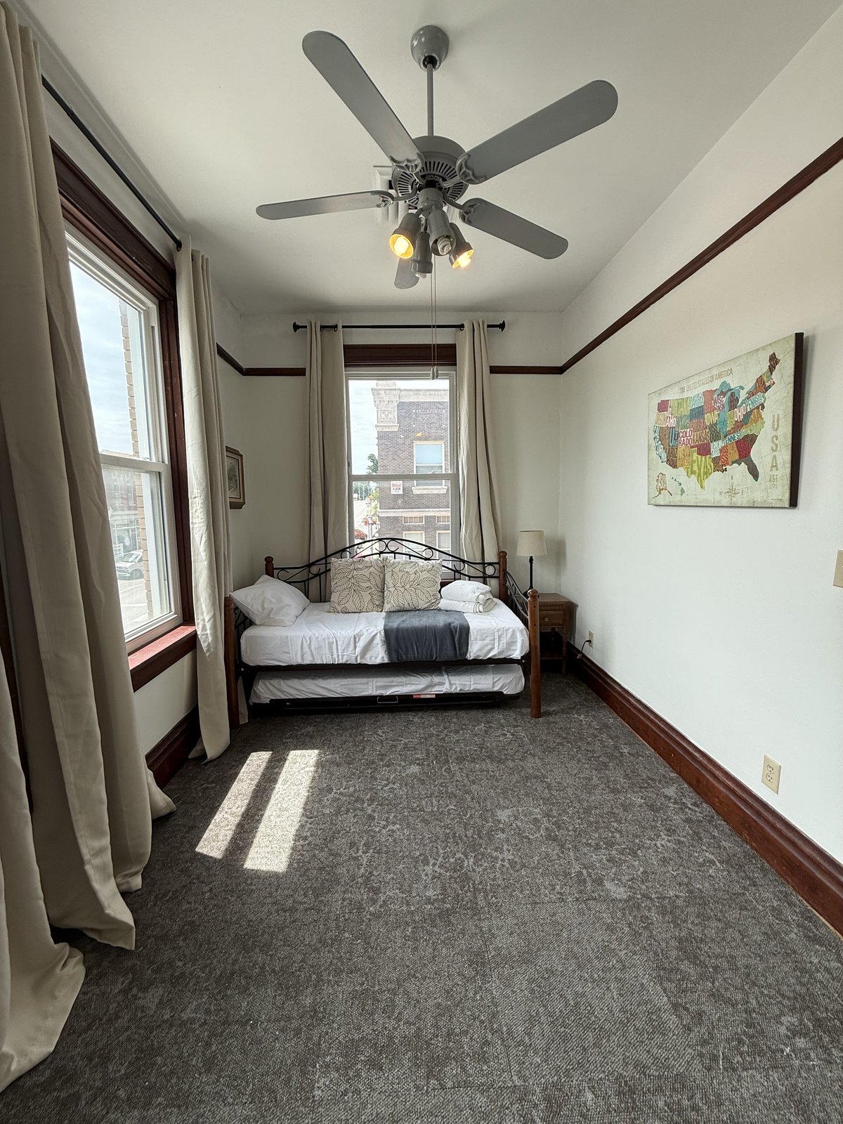 Bedroom 3 — ceiling fan, large windows, hardwood floors
